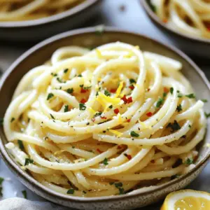 - 400g spaghetti - 6 cloves of garlic, thinly sliced - ½ cup extra virgin olive oil - 1 teaspoon red pepper flakes - Zest and juice of 1 lemon - ¼ cup fresh parsley, chopped - Salt, to taste - Grated Parmesan cheese (optional) If you want to switch things up, consider these options: - Use avocado oil or grapeseed oil instead of olive oil. - Try shallots if you can’t find garlic. - Use fresh chili instead of red pepper flakes for more heat. Gather these tools before you start: - Large pot for boiling water - Skillet for making the garlic oil - Kitchen utensils like spaghetti tongs and a knife Spaghetti Aglio e Olio is simple yet full of flavor. With just a few ingredients, you can create a dish that shines. You can find the full recipe to guide you through each step. Enjoy cooking! 1. Start by boiling salted water in a large pot. This helps flavor the pasta. 2. Add 400g of spaghetti to the boiling water. Cook it until al dente, about 8-10 minutes. 3. Remember to reserve 1 cup of the pasta water before draining. This water helps later. 1. In a large skillet, heat ½ cup of extra virgin olive oil over medium heat. 2. Add 6 cloves of thinly sliced garlic. Sauté the garlic until it turns golden, about 2-3 minutes. 3. Once golden, add 1 teaspoon of red pepper flakes. Stir for about 30 seconds to release their flavor. 1. Add the drained spaghetti to the skillet with the garlic oil. 2. Pour in the reserved pasta water, starting with ½ cup. Toss well to coat the pasta. 3. Stir in the zest and juice of 1 lemon to brighten the dish. Adjust seasoning with salt if needed. For the full recipe, check the section above. To make the best garlic oil, start by heating the olive oil over medium heat. Watch the garlic closely. If it burns, it turns bitter. You want it golden, not brown. This takes about 2-3 minutes. Once the garlic is golden, add red pepper flakes. The spice level is up to you. Start with one teaspoon. You can always add more later if you want more heat. For a beautiful plate, use shallow bowls. This helps show off the lovely colors. Add extra parsley on top for a pop of green. A drizzle of olive oil adds shine. You can also add a lemon wedge on the side. This gives a fresh touch and makes it look fancy. As for sides, a simple green salad works well. Garlic bread is also a great choice! Serve your pasta hot for the best taste. Keep it warm by covering it with a lid. If you have leftovers, reheat them gently. Use a skillet over low heat. Add a splash of water or olive oil to keep it moist. Stir often to heat evenly. Avoid the microwave if you can. It can dry out the pasta. Enjoy your delicious Spaghetti Aglio e Olio! {{image_2}} Classic Spaghetti Aglio e Olio is simple yet delicious. It uses just garlic, olive oil, and pasta. This dish shines with few ingredients. You can serve it as is or add more. For a modern twist, try adding proteins like chicken or shrimp. These additions create a heartier meal. If you follow a vegetarian or vegan diet, you can still enjoy this dish. Replace Parmesan cheese with a dairy-free alternative. Nutritional yeast works well for a cheesy flavor. You can also add extra vegetables for more taste. Sautéed spinach or roasted cherry tomatoes enhance the dish. Using fresh herbs makes this dish even better. Basil, parsley, or oregano add bright flavors. You can also incorporate seasonal vegetables. In spring, try asparagus or peas for a fresh crunch. In summer, zucchini or bell peppers bring color and taste. Each season offers new options to make this dish exciting. For the full recipe, check out Spaghetti Aglio e Olio with a Zesty Twist. To keep your Spaghetti Aglio e Olio fresh, store it in an airtight container. Place it in the fridge within two hours of cooking. This prevents bacteria growth. You can keep it for up to three days. After that, the flavors may fade. When reheating, avoid the microwave if possible. It can dry out the pasta. Instead, use a skillet over low heat. Add a splash of olive oil or reserved pasta water for moisture. Stir gently until warm. This keeps the dish tasty and fresh. Yes, you can freeze Spaghetti Aglio e Olio. However, the texture may change slightly. To freeze, place the cooled pasta in a freezer-safe bag. Remove as much air as you can. It will last for up to three months. To defrost, place it in the fridge overnight. You can also use the microwave on low power. Stir well to restore some of the original texture. Enjoy your delicious meal again! Spaghetti Aglio e Olio comes from Italy. It first appeared in Naples. This dish is simple. It uses basic ingredients found in Italian homes. Garlic, olive oil, and pasta make it special. People made it for quick meals. The dish gained fame for its flavor and ease. Now, it is loved worldwide. The spice level depends on you. The red pepper flakes add heat. You can use one teaspoon for a mild kick. For more heat, add more flakes. If you prefer less spice, use less or none. Taste as you go. Adjust to fit your palate. Yes, you can prep this dish ahead. Cook the spaghetti and garlic oil. Store them separately in the fridge. When ready, combine them. Heat gently before serving. This helps keep the pasta fresh. You can also save some pasta water. It helps with moisture when reheating. Enjoy a quick meal anytime! In this article, I explored the tasty recipe for Spaghetti Aglio e Olio. We covered essential ingredients, cooking steps, and helpful tips. With simple techniques, you can make this classic dish shine. Remember to adjust spice levels to fit your taste. You can also add proteins or veggies to make it your own. Enjoy sharing this dish with friends and family. Cooking should be fun and rewarding!