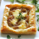 - 1 sheet of puff pastry, thawed - 3 large onions, thinly sliced - 2 tablespoons olive oil - 1 tablespoon butter - 1 teaspoon fresh thyme leaves - Salt and pepper to taste - 1 cup Gruyère cheese, grated - 1 egg, beaten (for egg wash) I love starting with puff pastry. It gives the tart a nice, flaky crust. Choose a high-quality pastry for the best result. Next, we need onions. You want them to be large and sweet. Slice them thinly for even cooking. Olive oil and butter are crucial for cooking onions. They add flavor and help with the caramelization process. Fresh thyme gives a lovely aroma. You may also like to add salt and pepper for taste. Gruyère cheese is rich and melts beautifully. Lastly, we need an egg to create a golden finish on the pastry. - Fresh arugula for garnish - Additional spices or herbs For a fresh touch, arugula is a great option. It adds color and a peppery bite. If you want more flavor, consider using spices or herbs. Options like rosemary or nutmeg can enhance your tart. - Preheat your oven to 400°F (200°C). This step is key for a crispy crust. - In a large skillet, heat 2 tablespoons of olive oil and 1 tablespoon of butter over medium heat. Add 3 large, thinly sliced onions and a pinch of salt. - Cook the onions, stirring often, for about 15 to 20 minutes. You want them soft and golden brown. Lower the heat if they darken too fast. - Stir in 1 teaspoon of fresh thyme leaves, plus salt and pepper to taste. Remove from heat and let them cool. - Roll out 1 sheet of thawed puff pastry on a lightly floured surface. Make it fit your tart pan. - Carefully transfer the pastry to the pan, pressing it gently into the edges. Trim any extra pastry. - Sprinkle half of 1 cup of grated Gruyère cheese evenly over the bottom of the tart. - Layer the caramelized onions on top of the cheese, spreading them evenly. - Top with the rest of the Gruyère cheese. - Brush the edges of the pastry with 1 beaten egg. This gives a golden color. - Bake the tart in the preheated oven for 25 to 30 minutes. Check for a golden brown pastry and bubbly cheese. - Remove it from the oven and let it cool for a few minutes before slicing. This step-by-step guide ensures your Savory Caramelized Onion and Gruyère Tart turns out perfect every time. Enjoy your cooking! - Cooking temperature: Use medium heat to cook the onions. This helps them soften slowly. High heat can burn them instead of caramelizing. - Stirring techniques: Stir the onions every few minutes. This keeps them cooking evenly and prevents sticking. If they start to brown too fast, lower the heat. - Thawing and rolling tips: Always thaw puff pastry in the fridge overnight. This keeps it from getting too sticky. When rolling, use a light dusting of flour to avoid sticking. - Avoiding soggy crust: Sprinkle a bit of cheese on the bottom before adding onions. This acts as a barrier and keeps the crust crispy. - Plating ideas: Cut the tart into squares or triangles. Serve on a bright plate for a nice look. A sprinkle of fresh thyme on top adds color. - Pairing suggestions with drinks: This tart pairs great with a crisp white wine. A light salad with lemon dressing also complements it well. Try serving it with sparkling water for a refreshing touch. {{image_2}} You can switch Gruyère cheese for other tasty options. Try aged cheddar for a sharp bite. Feta adds a creamy and tangy flavor. Goat cheese brings a rich, earthy taste. You can even mix cheeses for a unique blend. Just keep in mind that each cheese melts differently. You can add more veggies to your tart for extra flavor and nutrition. Spinach gives a nice color and taste. Mushrooms add an earthy depth. Roasted bell peppers bring sweetness. Zucchini can also add moisture. Just be sure to sauté any extra veggies before adding them to the tart. If you need a gluten-free option, use a gluten-free puff pastry. You can also make a crust with almond flour or chickpea flour. Both options give a nice texture. Just ensure that any flour you use meets your dietary needs. To store leftovers, let the tart cool completely. Wrap it tightly in plastic wrap or foil. Place it in an airtight container. This keeps it fresh for up to three days. When you're ready to eat, check for any signs of spoilage first. You can freeze the tart before or after baking. If freezing before baking, wrap it well in plastic wrap. Then, place it in a freezer-safe bag. This keeps it good for up to three months. If you freeze it after baking, let it cool first, then follow the same wrapping steps. To reheat without losing texture, use an oven. Preheat it to 350°F (175°C). Place the tart on a baking sheet. Heat for about 10-15 minutes. This method warms it evenly and keeps the crust crisp. You can also microwave individual slices, but the crust may get soft. Look for a golden brown crust. The cheese should bubble and melt. A knife inserted should come out clean, showing the tart is set. If the edges are nicely browned, it's perfect. Keep an eye on it during the last few minutes of baking. Yes, you can make this tart ahead of time. Prepare the caramelized onions and puff pastry, then assemble the tart. Cover it tightly and store it in the fridge for up to 24 hours. Bake it just before serving for the best taste. This tart pairs well with a fresh green salad. Try a simple arugula salad dressed with lemon and olive oil. You could also serve it with a light soup, such as tomato or butternut squash. A crisp white wine complements the flavors nicely too. This blog post covers how to make a savory caramelized onion and Gruyère tart. You learned about the main and optional ingredients, along with step-by-step instructions from prep to baking. I shared tips for perfect results, variations for creativity, and smart storage advice. Enjoy making this tart and experimenting with flavors. Keep these tips handy, and savor every bite. You will impress your friends and family with this dish!