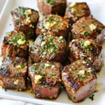 - 1 pound sirloin steak, cut into bite-sized pieces - 4 tablespoons unsalted butter - 4 cloves garlic, minced The star of this dish is the sirloin steak. It has rich flavor and tender texture. Cut it into bite-sized pieces for easy cooking. Next, we have unsalted butter. It adds creaminess and richness to the dish. The minced garlic brings a bold flavor that elevates the steak bites. - 1 teaspoon fresh rosemary, chopped - 1 teaspoon fresh thyme, chopped - 1 teaspoon paprika Fresh herbs like rosemary and thyme give a nice aroma. They add depth to the garlic butter blend. Paprika gives a hint of smokiness and a lovely color to the steak. These seasonings make each bite tasty and fragrant. - Salt and pepper, to taste - Fresh parsley, chopped (for garnish) Don’t forget the salt and pepper! They enhance all the flavors in this dish. Finally, fresh parsley adds a pop of color and a fresh taste. It makes your steak bites look beautiful on the plate. To start, we need to preheat the air fryer. Set it to 400°F (200°C) and let it warm up for about 5 minutes. This step is key to getting those steak bites nice and crispy. Next, we will season the steak bites. Take 1 pound of sirloin steak and cut it into bite-sized pieces. In a large bowl, mix the steak with 1 teaspoon of paprika, and add salt and pepper to taste. Toss everything well. This ensures that each piece is flavorful. Now it’s time to make our garlic butter. Take 4 tablespoons of unsalted butter and melt it in a small saucepan over low heat. Keep an eye on it so it doesn’t burn. Once the butter melts, add 4 minced garlic cloves, 1 teaspoon of chopped rosemary, and 1 teaspoon of chopped thyme. Stir this mixture for about 1-2 minutes until it smells amazing. This fragrant mix is what gives the steak its rich taste. Pour the garlic butter over the seasoned steak bites. Toss them to coat evenly. This step makes sure every bite is packed with flavor. Place the steak bites in the air fryer basket. Make sure they are in a single layer. Do not overcrowd them; this helps them cook evenly. Air fry the steak bites for about 8-10 minutes. Halfway through, shake the basket gently. This helps them brown nicely. To check for doneness, use a meat thermometer. Aim for 135°F (57°C) for medium-rare. When they are ready, transfer the steak bites to a serving plate. Drizzle any leftover garlic butter on top. Finally, garnish with fresh chopped parsley for a pop of color and freshness. Enjoy! To get perfect doneness, you need to know your steak. For medium-rare, aim for 135°F (57°C). Use a meat thermometer for the best results. Remember, the steak will cook a bit more after you take it out. Tossing the steak bites is key. It helps coat all the pieces in the garlic butter. This means every bite is packed with flavor. Don't skip this step! If you want to shake things up, try other seasonings. Consider using cumin or chili powder for a spicy kick. You can also add a splash of soy sauce for depth. Marinating the steak can boost the flavor. Try a simple marinade of olive oil, balsamic vinegar, and garlic. Let it sit for a few hours or overnight for the best taste. Always handle raw steak with care. Wash your hands before and after touching it. Use separate cutting boards for meat and veggies to avoid cross-contamination. When it comes to leftovers, store them in an airtight container. They should stay good in the fridge for about three days. If you won’t eat them soon, consider freezing them. {{image_2}} You can switch up the steak for different cuts. Try ribeye or flank steak. They both offer a rich taste and tenderness. If you want variety, consider chicken or shrimp. Both cook quickly in the air fryer. Each protein brings a unique flavor and texture. Want to spice things up? Add chili flakes for some heat. They give a nice kick without overpowering the dish. You can also mix in other herbs. Fresh basil or oregano can add depth. Experiment with flavors that you love. Pair these steak bites with tasty sides. Roasted veggies or a fresh salad work great. They balance the richness of the garlic butter. For sauces, try a creamy ranch or tangy chimichurri. These dips enhance the meal and make it more fun to eat. To store garlic butter steak bites, place them in an airtight container. This keeps them fresh and tasty. Let the bites cool down before you pack them. In the fridge, they last for 3 to 4 days. Check for any signs of spoilage before eating. When you’re ready to enjoy your leftovers, the air fryer is best. Set it to 350°F (175°C). Heat the steak bites for about 5 minutes. This method keeps them juicy. To avoid toughness, do not overcook them. Always check the bites to ensure they are warm but not dry. If you want to freeze the steak bites, first let them cool completely. Then, put them in a freezer-safe bag. Remove as much air as you can to prevent freezer burn. They can be stored for up to 3 months. To thaw, place them in the fridge overnight. Reheat in the air fryer as mentioned above for the best results. To check if your steak bites are done, use a meat thermometer. Insert it into the thickest piece. For medium-rare, look for 135°F (57°C). You can also rely on visual cues. Cooked steak should have a nice brown crust. The inside should be pink for medium-rare. If you prefer it more done, aim for a deeper brown inside. Yes, you can use frozen steak. First, thaw it properly. Place the steak in the fridge overnight or use cold water for a quick thaw. When cooking, add a few extra minutes to the cooking time. Check doneness with a thermometer to be safe. For side dishes, I recommend crispy roasted potatoes or fresh green beans. Both pair well with the rich flavor of steak. For drinks, a bold red wine complements the savory taste. A light beer can also balance the meal. Enjoy your feast! In this post, we explored how to make garlic butter steak bites using sirloin steak, fresh garlic, and herbs. We covered seasoning, cooking, and storage tips to help you succeed. Remember, achieving perfect doneness and trying new flavors can elevate your dish. Don’t hesitate to experiment with different meats and sides. With these steps, you can enjoy a tasty meal that impresses. Get cooking and enjoy every bite!